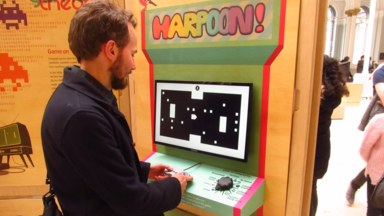 A visitor playing the Harpoon! game.