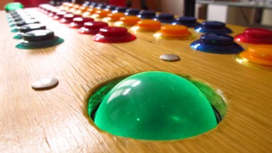 A close-up shot of the controller's illuminated trackball.