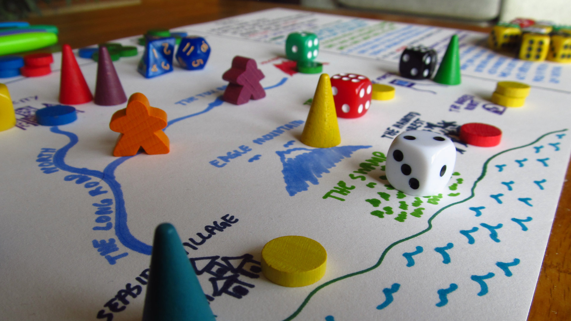 Close up of a game of making it up as we go along, with the game board and various dice and wooden pieces in the foreground