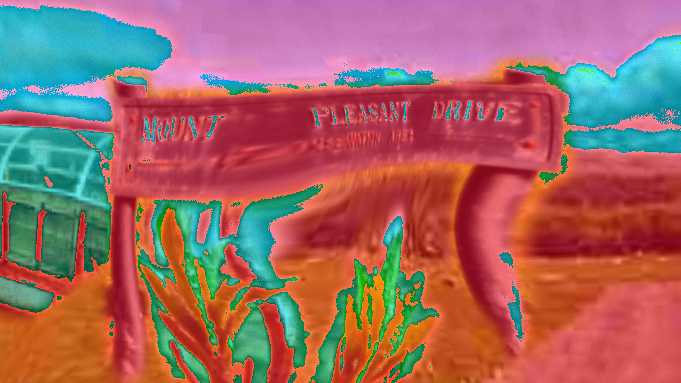 A screenshot of the work. A street sign saying 'Mount Pleasant Drive', distorted and hue shifted.